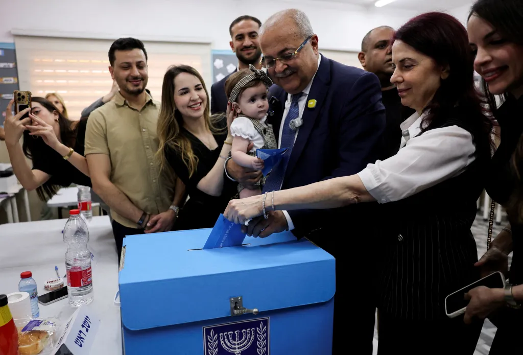 Palestinian candidate Ahmad Tibi of the Joint List party votes with his family during the national election in Taibe, northern Israel.